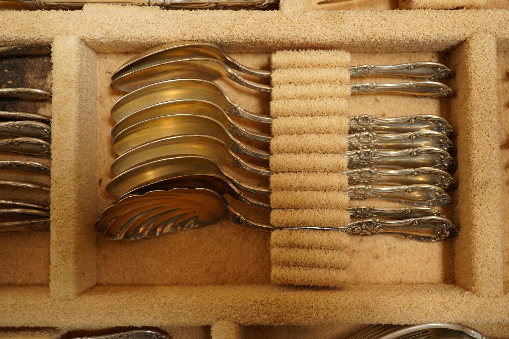 A cased part canteen of American sterling cutlery, weighable silver 63.8oz, together with four silver plated table forks. Condition - poor to fair